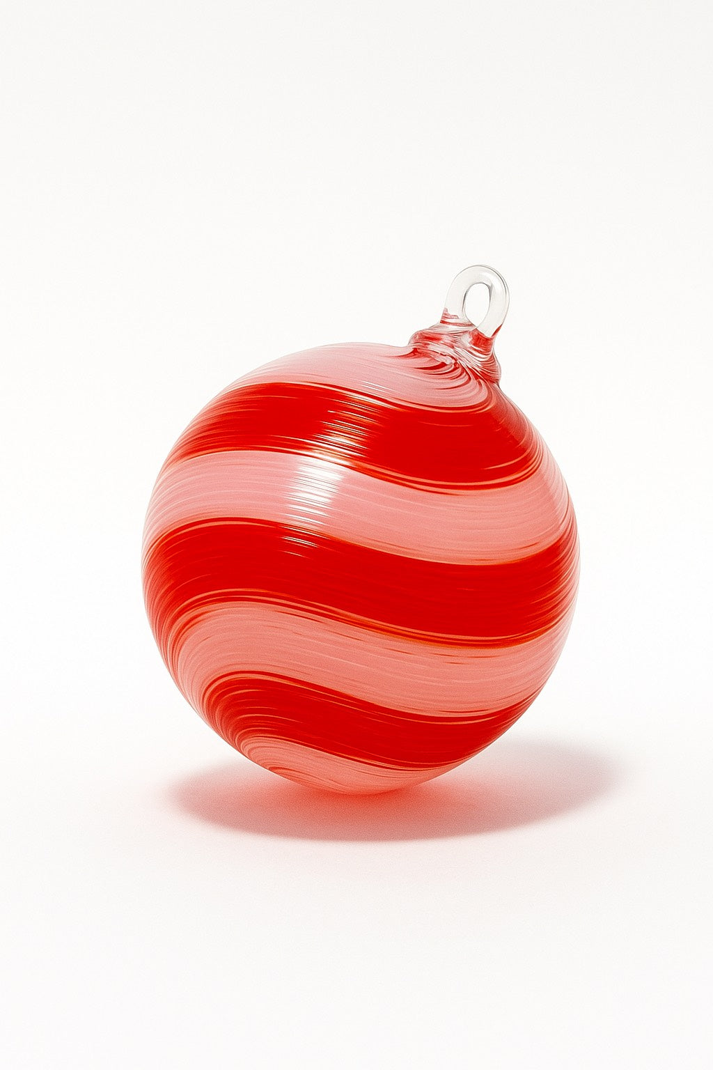 Hand-blown red and white swirl glass ornament with candy cane stripes from Puget Sound Glassblowing Studio.