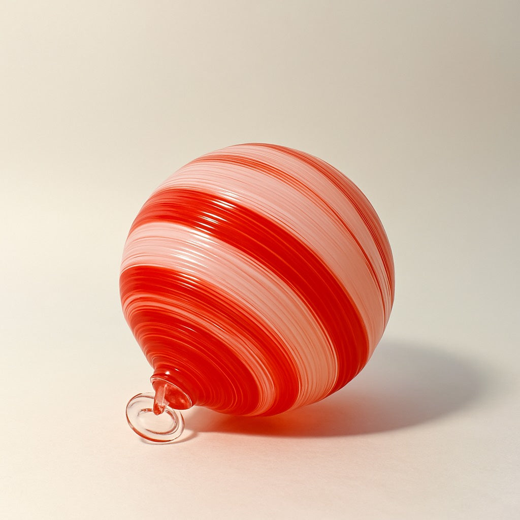 Hand-blown red and white swirl glass ornament with candy cane stripes from Puget Sound Glassblowing Studio. 