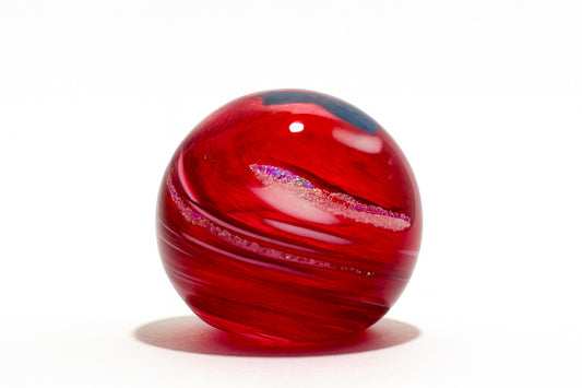 Hand-blown Red Galaxy glass paperweight with swirling crimson and White design from Puget Sound Glassblowing Studio.